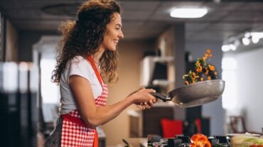 The woman is cooking